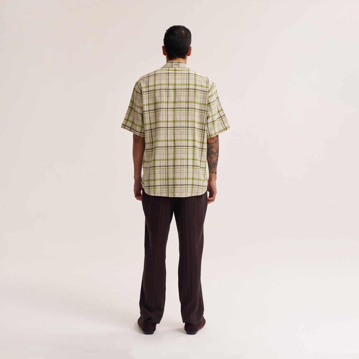 Sleeve and cuff detail of off white and green cotton shirt