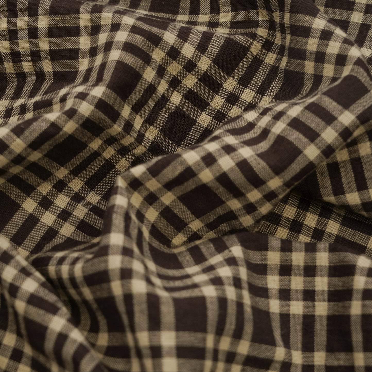 Close-up of handwoven dark brown check fabric