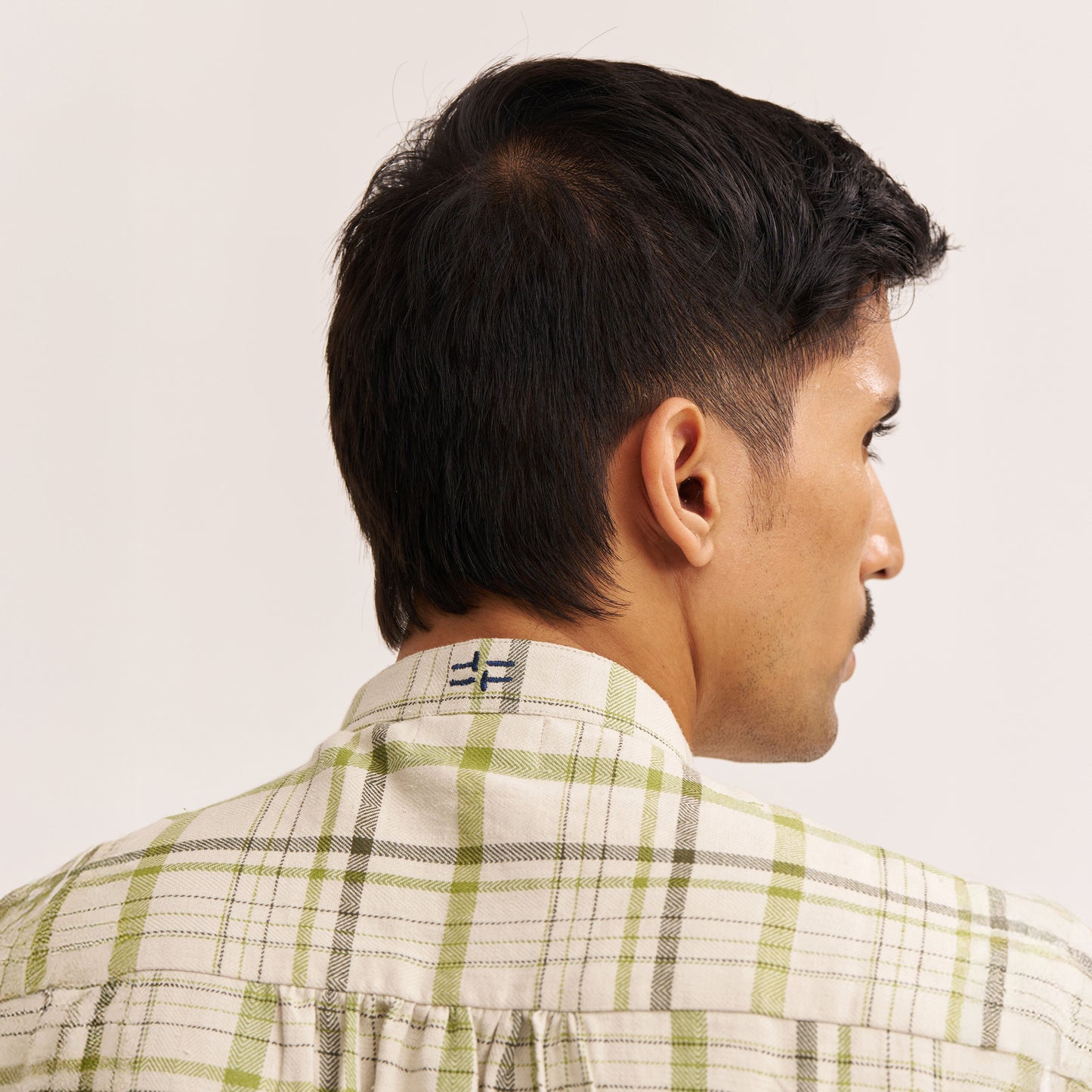 Close-up of band collar and check fabric texture
