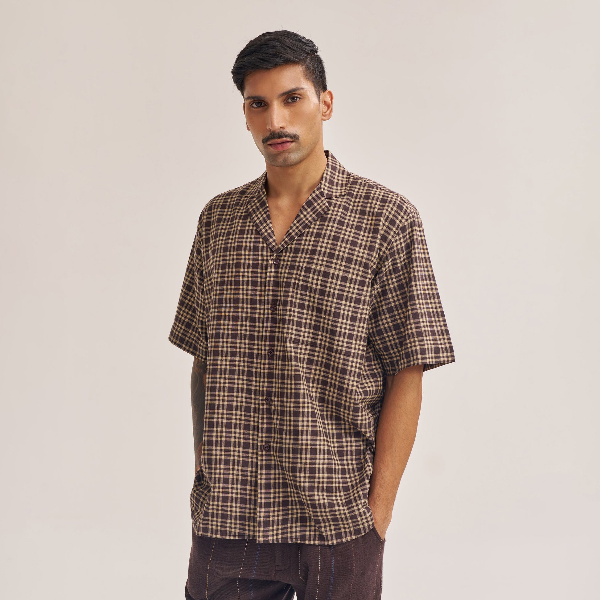Close-up of dark brown check pattern on handwoven cotton fabric