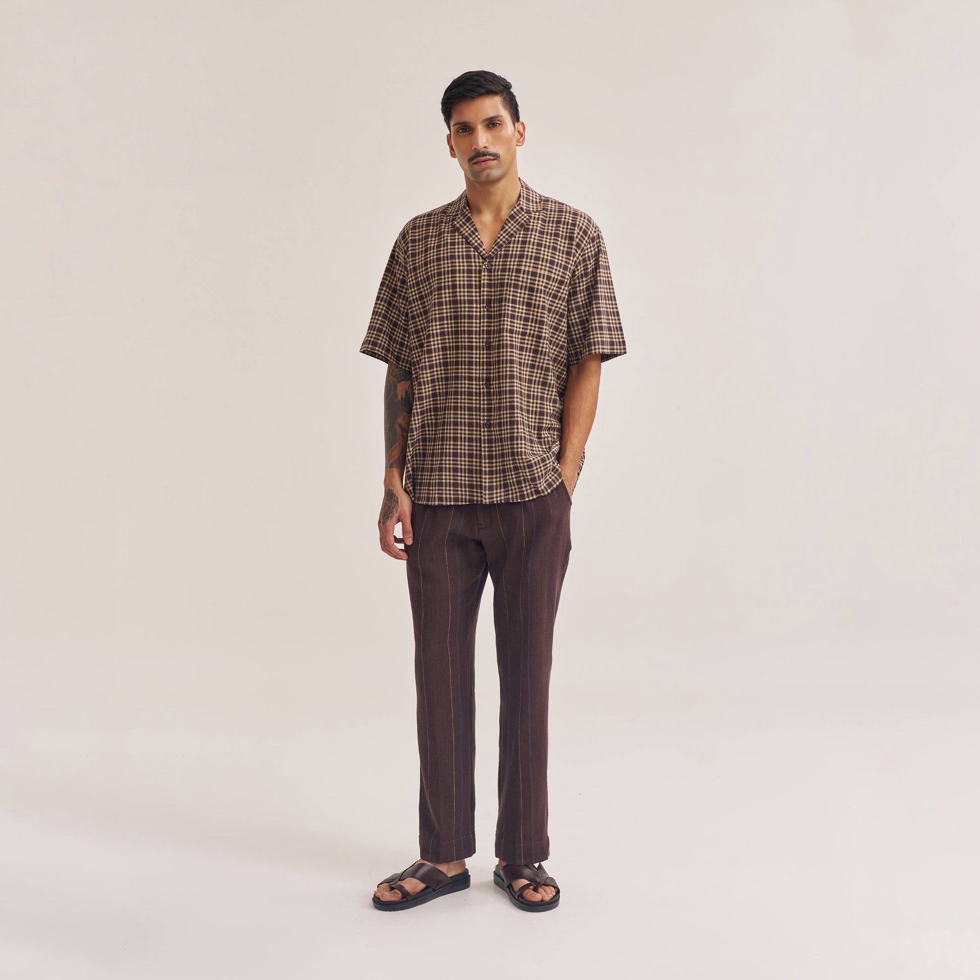 Collar and button detail of dark brown check shirt