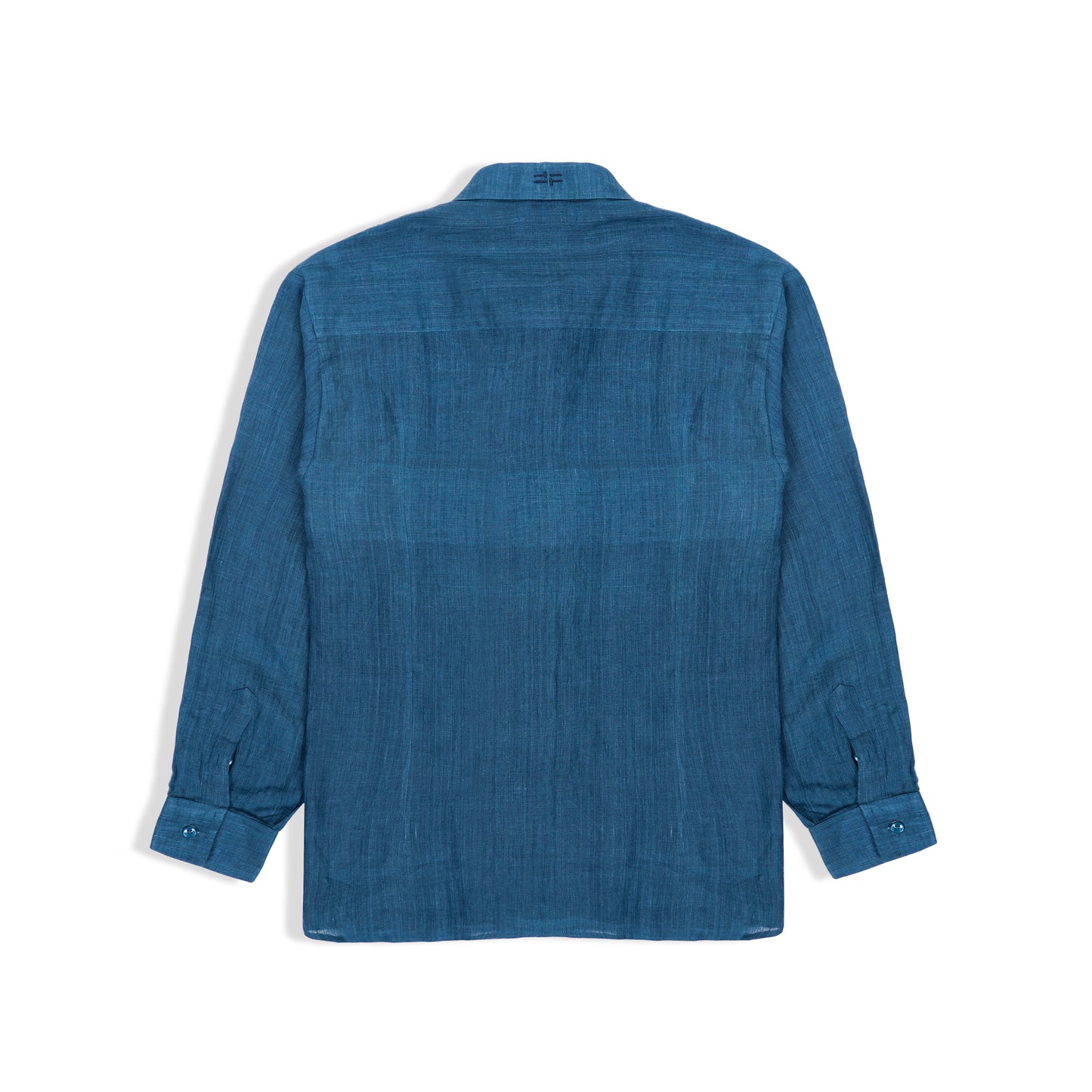 Side view of indigo linen shirt styled with trousers