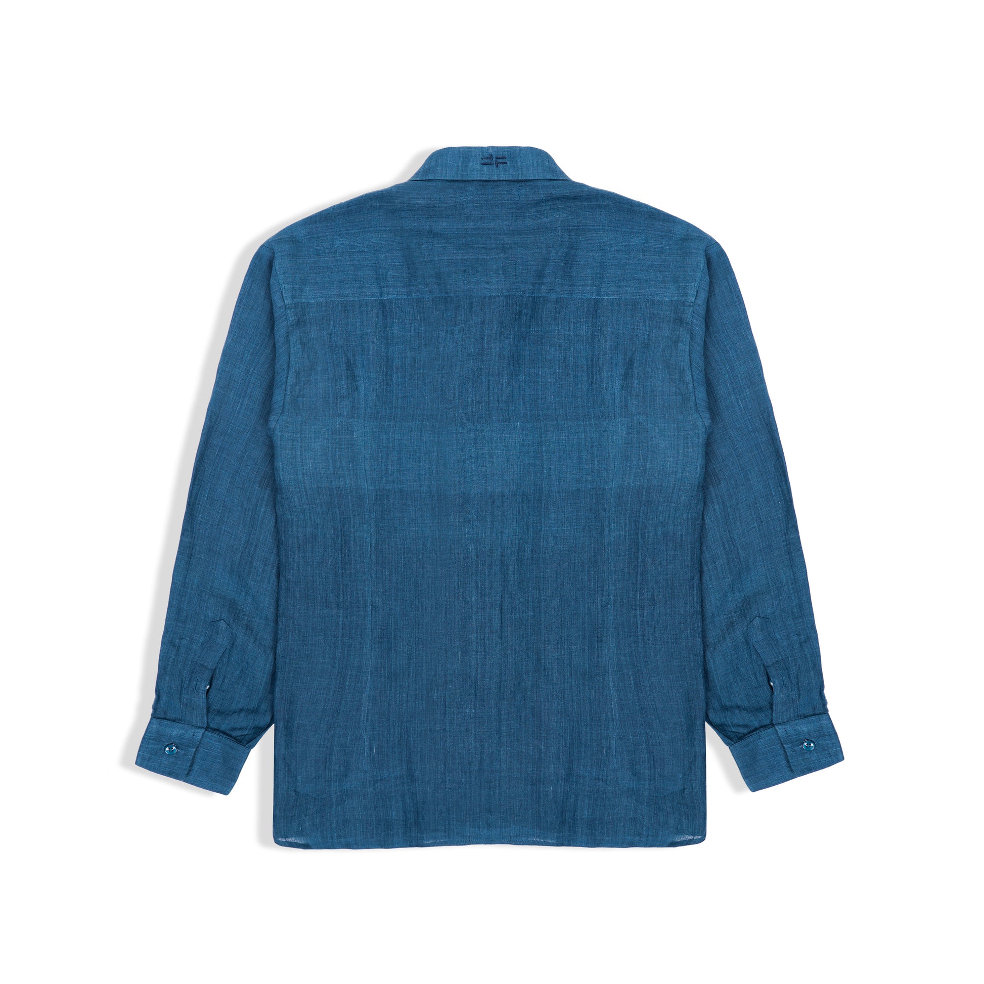 Side view of indigo linen shirt styled with trousers
