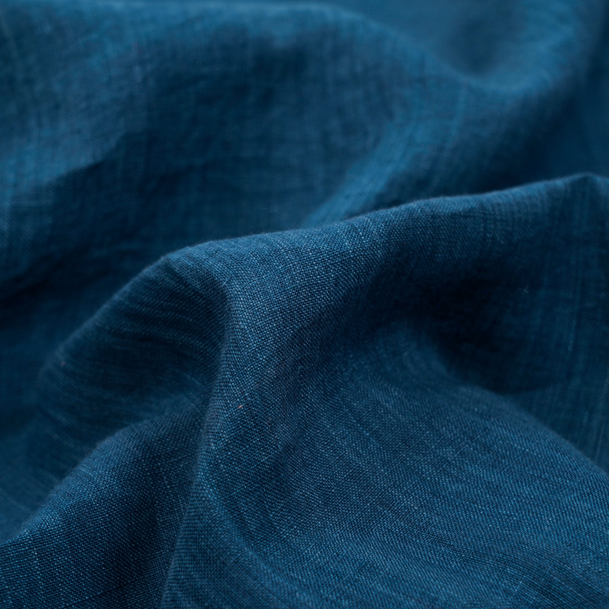 Collar and button detail of indigo linen shirt
