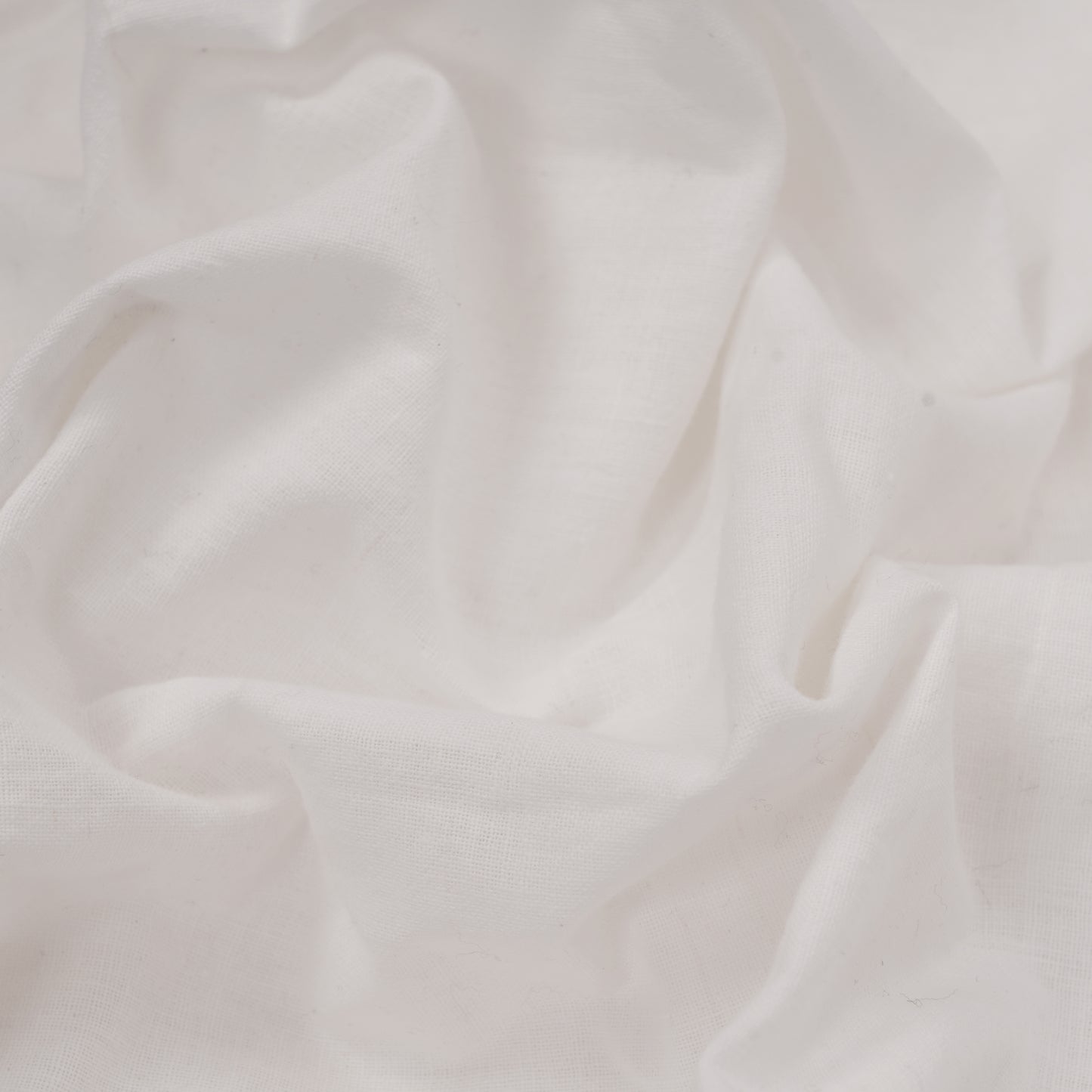 Close-up of white handwoven cotton fabric texture