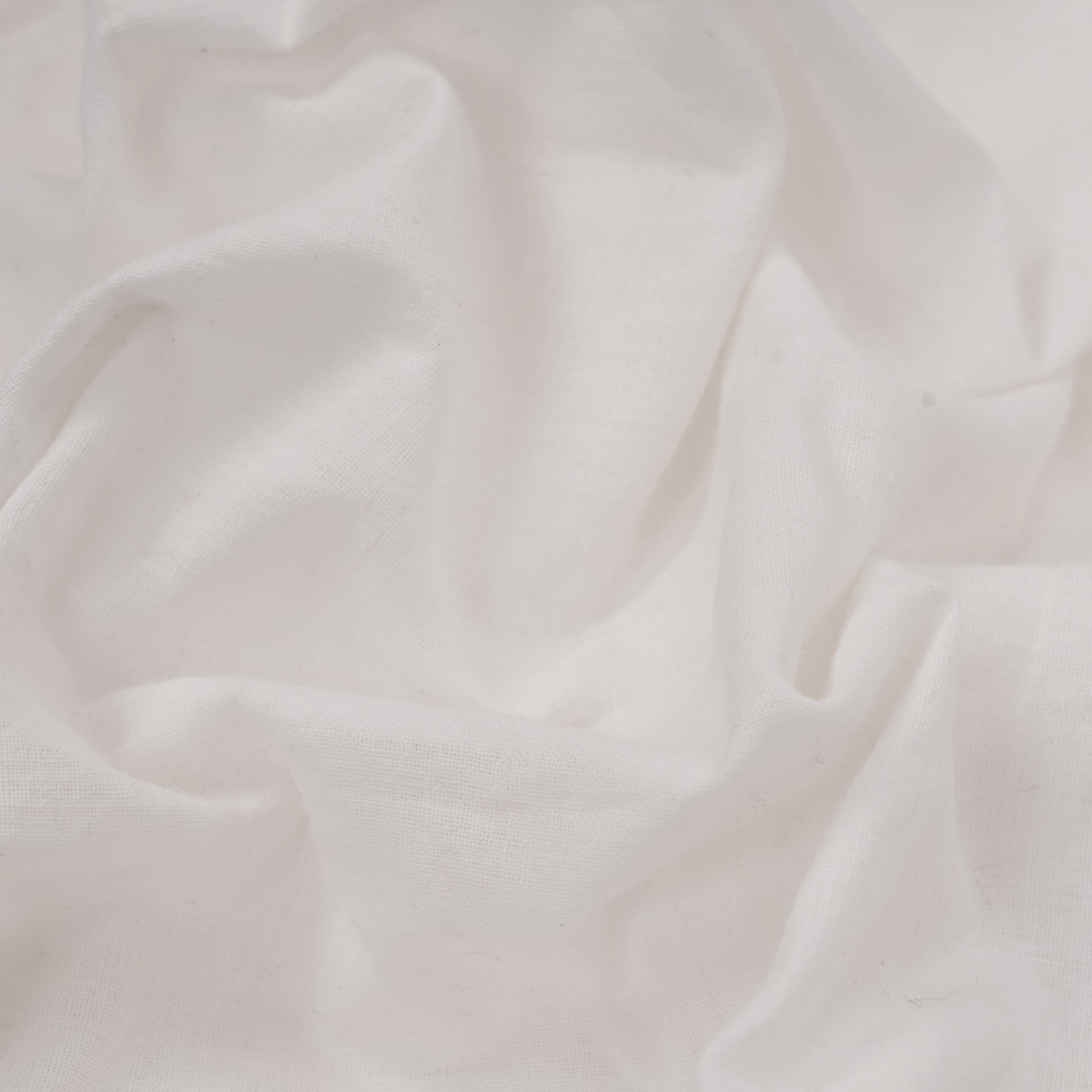 Close-up of white handwoven cotton fabric texture
